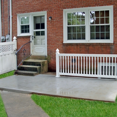 new concrete steps to basement and patio with railing